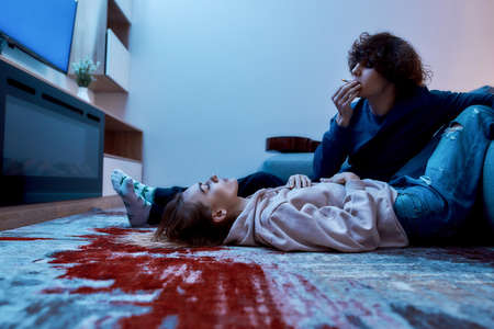 Young couple smoking marijuana weed, cannabis together and relaxing at home.の写真素材