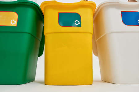 Set of three colorful green, yellow and white recycle garbage bins with recycle sign on it isolated on white background. Waste separation conceptの写真素材