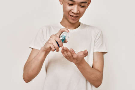 Protect your health. Cropped portrait of young asian man with clean shaven face holding hand...