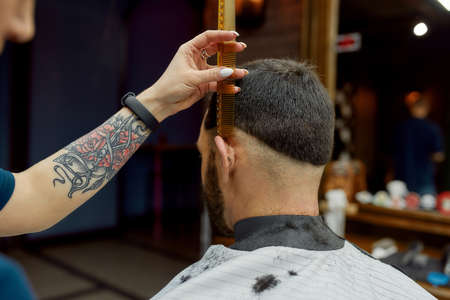 Perfect work. Close up shot of professional barber making trendy haircut for client