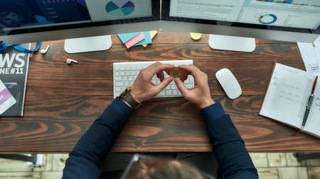 Top view of a businessman or sales manager working with statistical data, graphs, charts online...