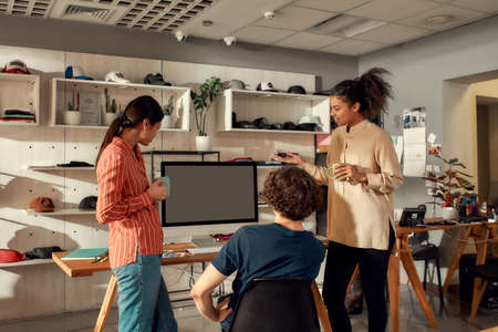 Passion, quality, innovation. Portrait of smiling workers drinking coffee and discussing ideas....