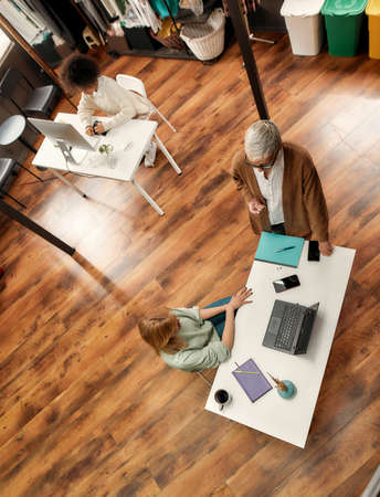 A creative process in a group of female of different age colleagues working together in a spacy...