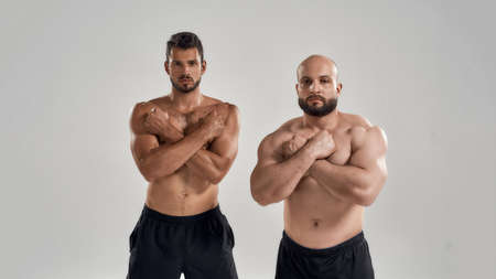 Young handsome muscular caucasian men with crossed fistsの写真素材