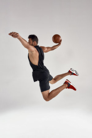 Young handsome caucasian professional male athlete with ballの写真素材