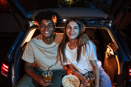 Happy diverse young couple having fun together. Cheerful guy and his girlfriend smiling while...