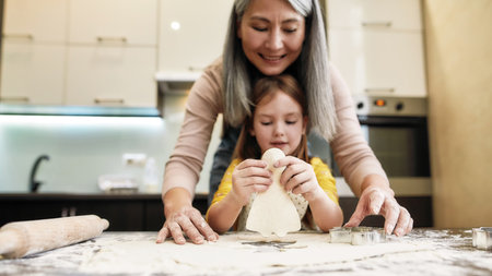 Cutted from dough cookie in little girl hands