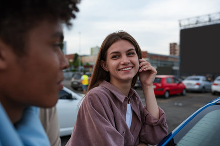 Selective focus on young girl smiling to man at autocinemaの写真素材