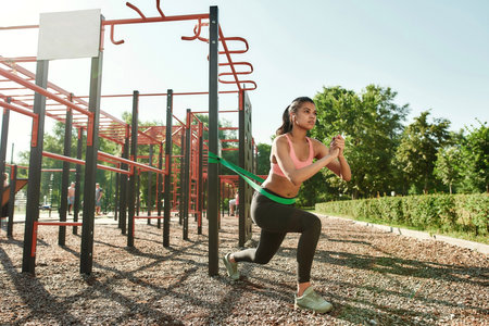 Full length shot of focused young mixed race woman working out w