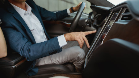Young businessman using car computer inside luxury carの写真素材