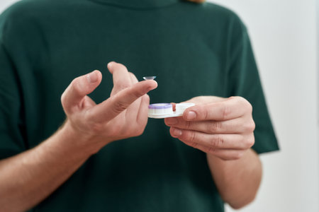 Selective focus on male finger holding contact lensの写真素材