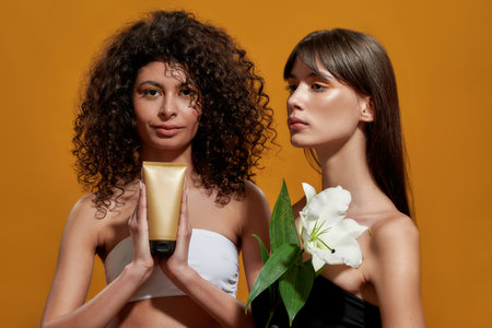 Lady holding a cream between her palms with her partnerの写真素材