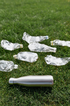 Reduse, refuse, recycle. Close up shot of a reusable metal water bottle or stainless thermos around...