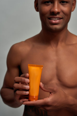Orange tube presented by an Afro-American adultの写真素材