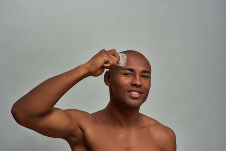 Optimistic confident man doing a pore cleaning with scraperの写真素材