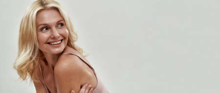 Smiling middle aged caucasian female model in lingerie
