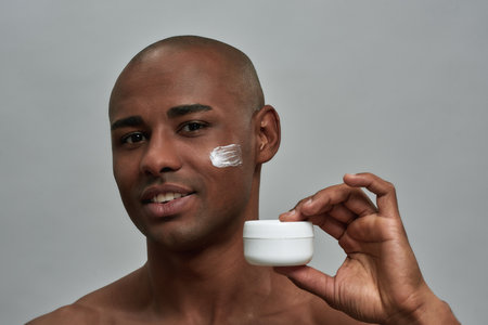 Person showing a cream container with a smileの写真素材