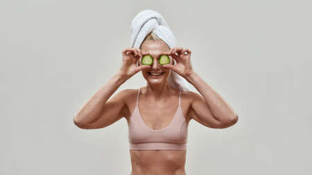 Cucumber slices before a face of Caucasian woman