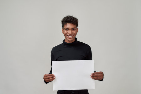 Young african american man holding blank posterの写真素材