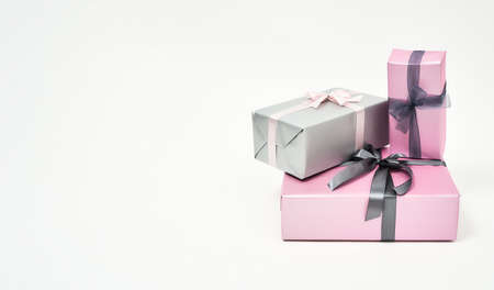 International Womens Day Gifts and Presents. Three colorful wrapped gift boxes with bows against white backgroundの写真素材