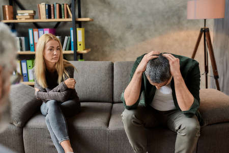 Depressed young caucasian couple during appointment in cabinet