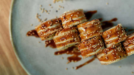Top view of traditional fresh sushi roll set with unagi and sesame served on a plateの写真素材
