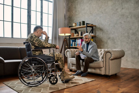 Professional psychotherapist talking to disabled manの写真素材