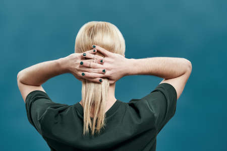 Rear view of groomed young man with manicured handsの写真素材