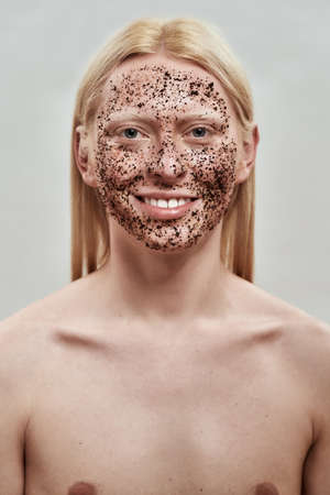 Groomed young caucasian man with scrub on his faceの写真素材