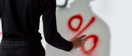 Young african american boy writing percents sign on wallの写真素材