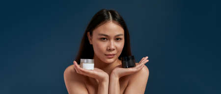 Girl with clean skin and cosmetics in hand