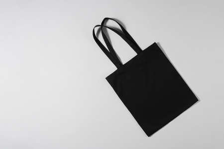 Black bag lying on a light backgroundの写真素材