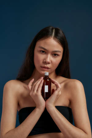 Beautiful girl in the studio with a care productの写真素材