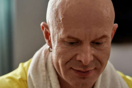 Portrait of middle aged caucasian athlete resting in roomの写真素材