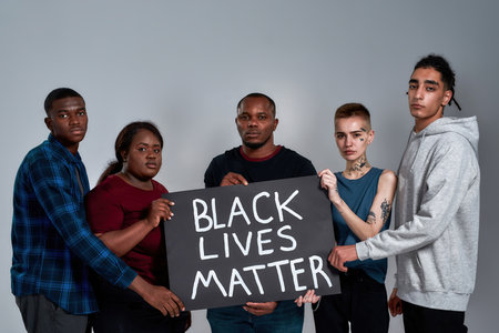 Black Lives Matter banner in multiracial people handsの写真素材
