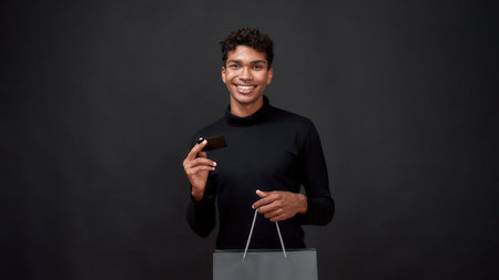 Cheerful african american man with packet and plastic card