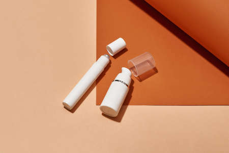 Close up shot of white plastic pump bottle and tube for eye roller luxury beauty products isolated...