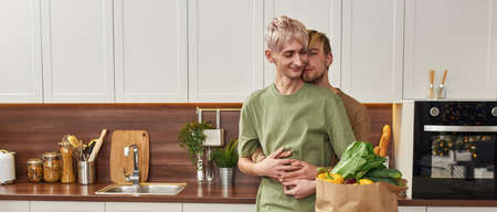 Happy homosexual male pair tenderly huggingの写真素材