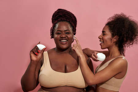 Mulatto courts after her extra sized afro female friendの写真素材