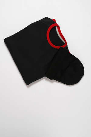 Flat lay of folded black cotton long sleeve and beanie hat isolated over white backgroundの写真素材