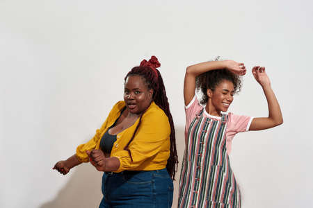 Two afro women dancing and catching the rhythmの写真素材