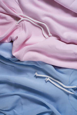 Close up shot of two pale blue and pink pastel blank cotton hoodie. Template