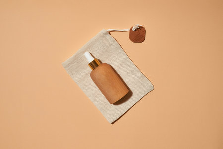 Cosmetological bottle lying on cotton bagの写真素材