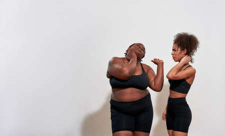 Picture of two african women kneading their necks