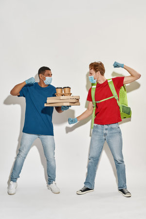 Multiracial young men boxing during working dayの写真素材
