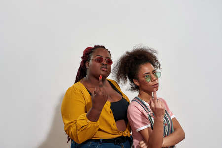 Two afro women saying Fuck you with no words