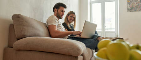 View from the bottom on a young couple who are discussing something on the couch