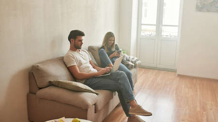 View from the top on couple spending time on couchの写真素材