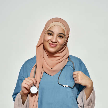 Portrait of smiling young arabian woman in doctor outfitの写真素材