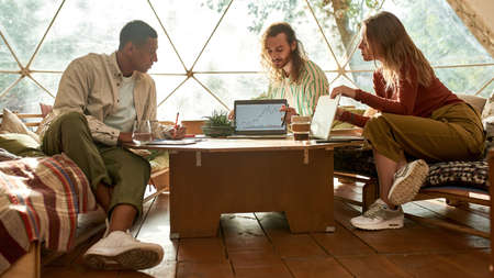 Team of young multiracial freelancers discussing project